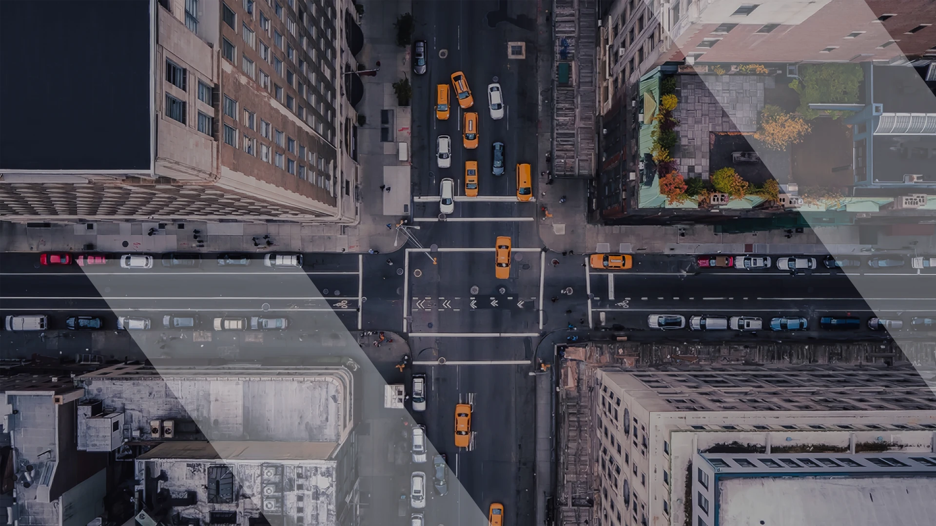 Overhead view of a busy city intersection with yellow taxis and other vehicles, symbolizing dynamic and fast-paced innovation similar to digital start-ups